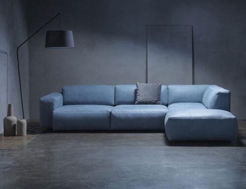 sofa azul con lampara en una sala
